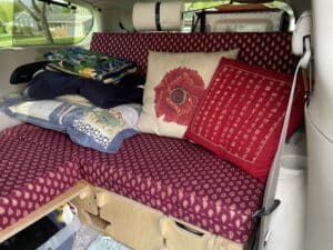 My couch with storage underneath and my bedding which I fold up every day. This picture was taken before the Reflectix and the shelves were installed.